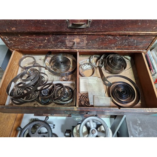 73 - A five drawer horologist's chest and contents comprising watch and clock making spares.