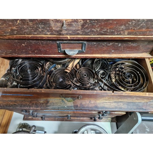 73 - A five drawer horologist's chest and contents comprising watch and clock making spares.