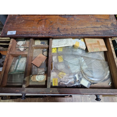 74 - A horologist's five drawer chest and contents comprising watch and clock making spares.