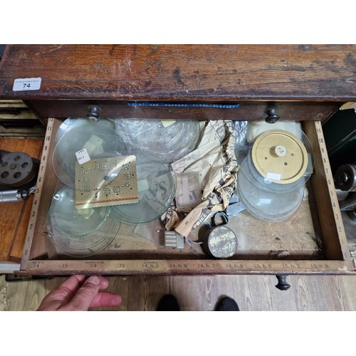 74 - A horologist's five drawer chest and contents comprising watch and clock making spares.