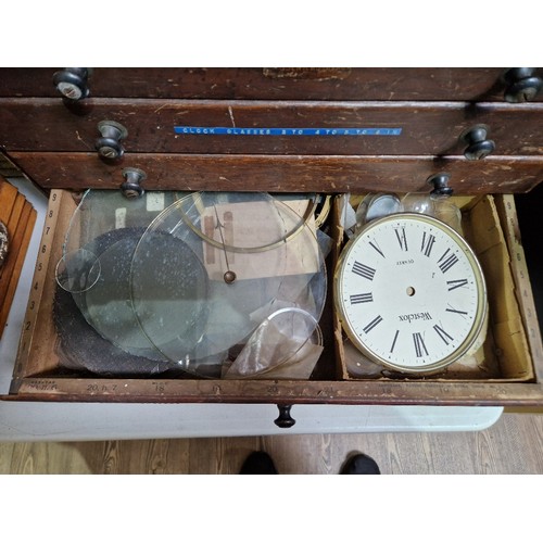 74 - A horologist's five drawer chest and contents comprising watch and clock making spares.