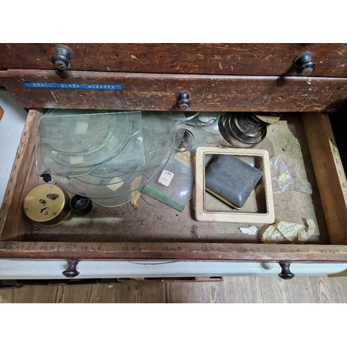 74 - A horologist's five drawer chest and contents comprising watch and clock making spares.