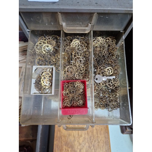 77 - Wooden, plastic and metal cabinets of watch spares.