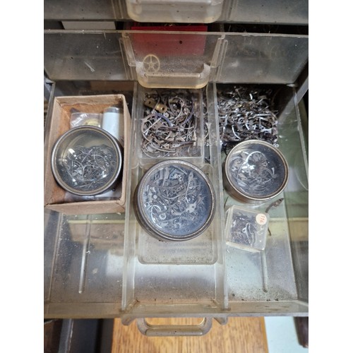 77 - Wooden, plastic and metal cabinets of watch spares.