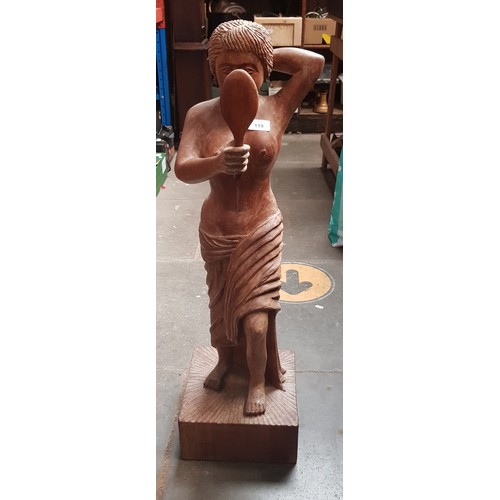 119 - An Eastern carved wood figure of a woman, height 83cm.