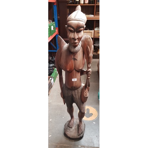 117 - An African carved hardwood figure depicting a warrior, height 120cm.