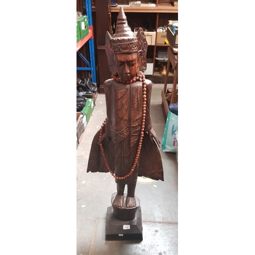 118 - An Eastern carved wood figure of a woman, height 115cm.