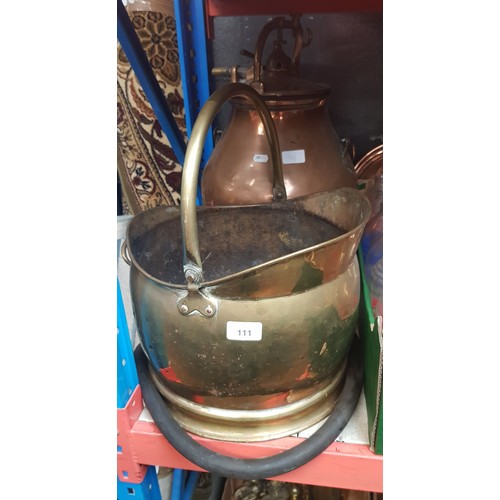 111 - A copper and brass pressurised flagon and a brass coal hod and two bed warming pans.