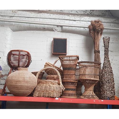 169 - A collection of assorted wicker ware including baskets, planters etc.