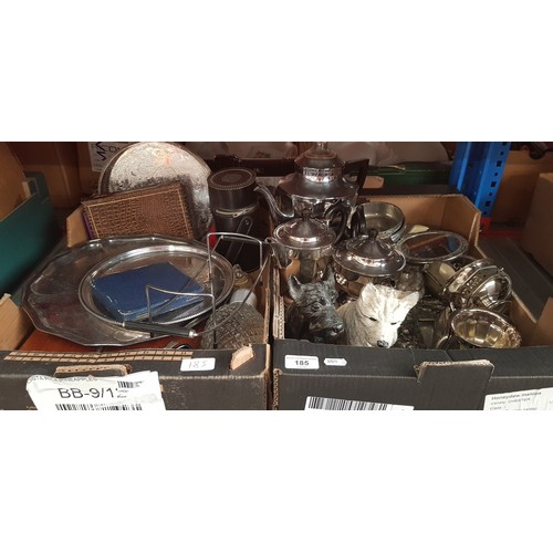 185 - Two boxes of assorted metal ware including silver plated ware, a pair of cast metal scotty dogs etc.