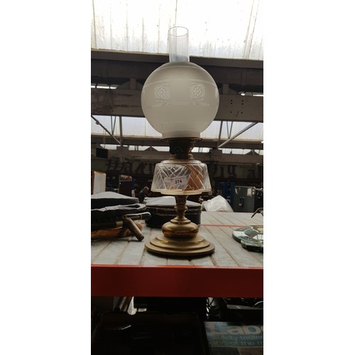 274 - A brass based oil lamp with funnel and glas shade