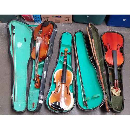 298 - Three Chinese Skylark student violins, each with bow and hard case.