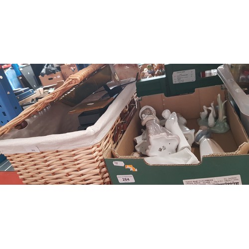 284 - A box of Nao figures (7) and a wicker hamper with kitchen scales