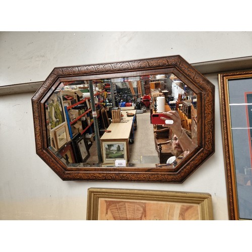 886 - An oak framed mirror, 66cm x 43.5cm.