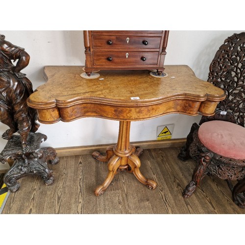 959 - A Victorian walnut pedestal card table, serpentine top with brown baize and tooled leather interior,... 