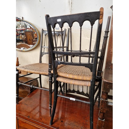 974 - Three late Victorian Aesthetic movement ebonised and cane seat chairs.