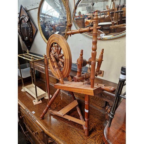 975 - A mahogany spinning wheel.