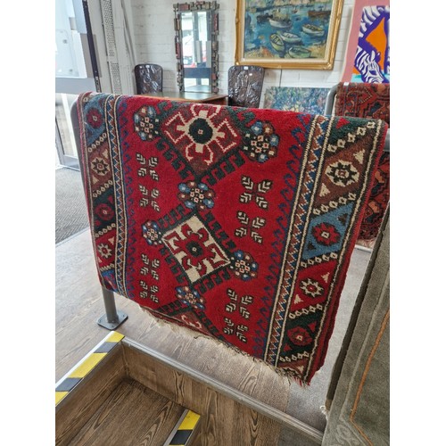 952 - A Eastern hand knotted wool runner, red ground, geometric pattern, 79cm x 120cm (approx)