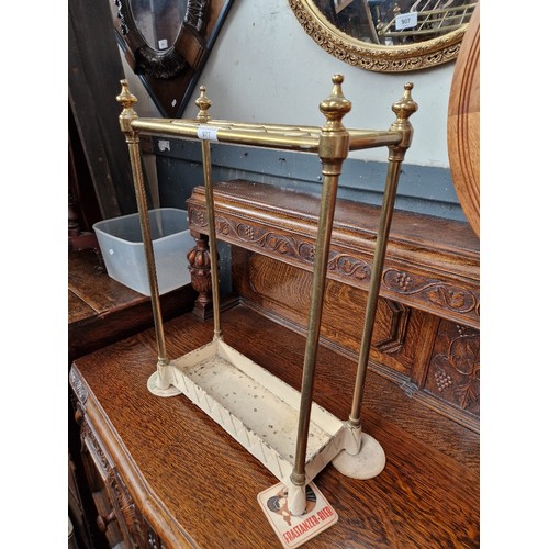 977 - A Victorian cast iron and brass stick stand.