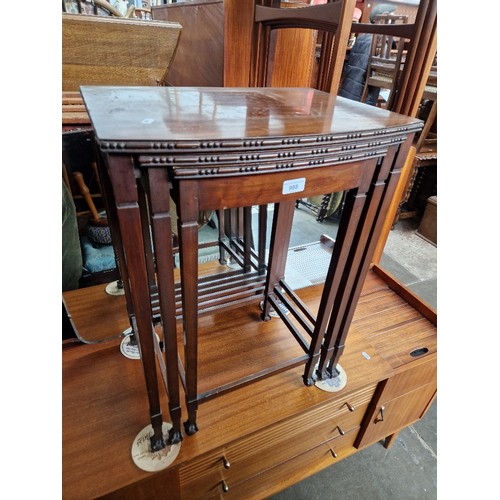 988 - A 1920s mahogany nest of tables with ball & claw feet.