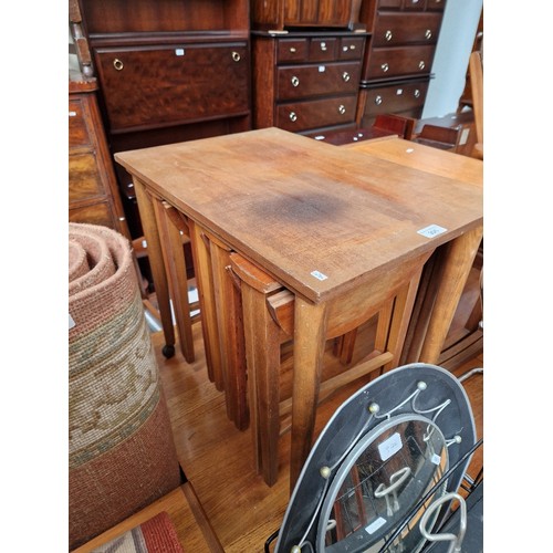 996 - A mid 20th century Danish teak nest of folding tables by Poul Hundevad.