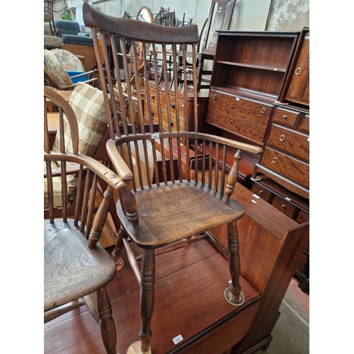 1004 - A 19th century beech and elm comb back Windsor chair.