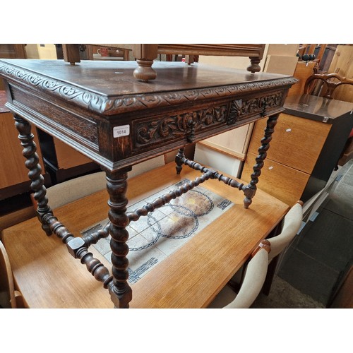 1014 - An early 20th century carved oak side table on twist supports.