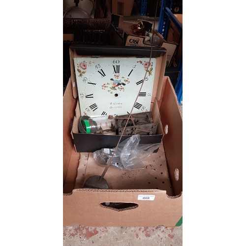 408 - A box of grandfather clock parts including face, movement, pendulum and weights