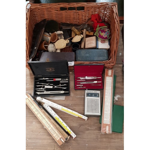 478 - A basket of mixed collectables including drawing sets, slide rules, etc.