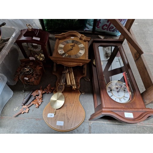 134 - A group of assorted clocks including a cuckoo clock & a granddaughter clock etc.