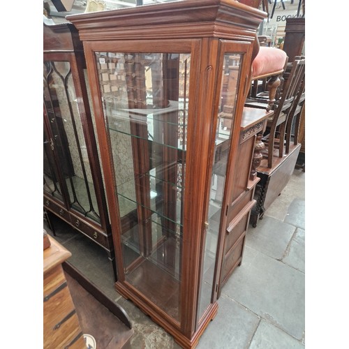 1031 - A cherrywood and bevelled glass display cabinet.