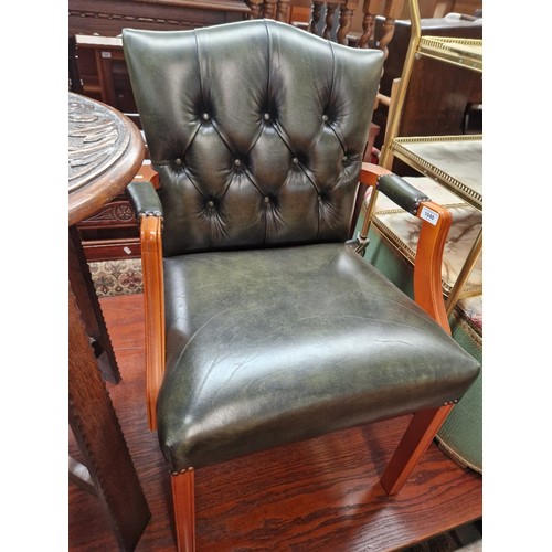 1040 - A green leather Gainsborough style chair.