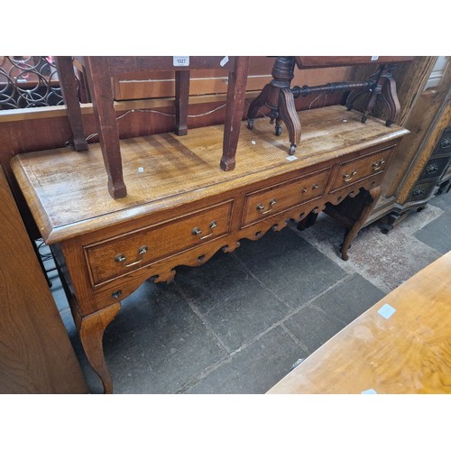 1026 - A crossbanded oak sideboard/dresser base, circa 1900, length 154cm.