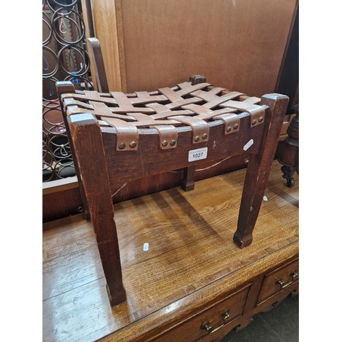 1027 - An early 20th century Arts & Crafts oak and latticed leather stool in the manner of Arthur Simpson o... 