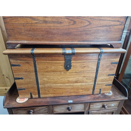 1018 - A metal bound hardwood chest.