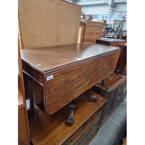 1050 - A 19th century mahogany pedestal Pembroke table with lion paw feet.