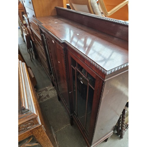 1064 - An early 20th century glazed mahogany side cabinet.