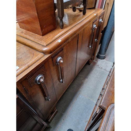 1045 - A 1920s Art Deco oak sideboard by E Gomme, label dated 1925.