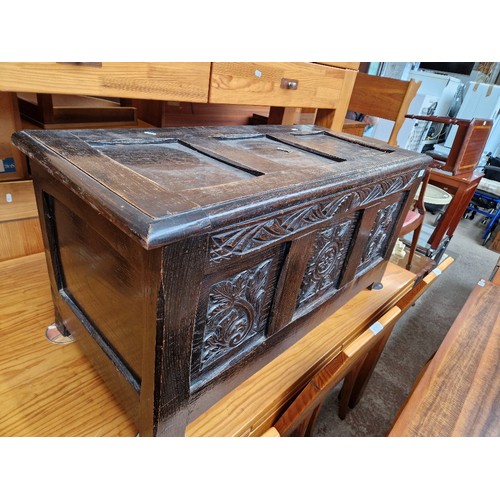 1069 - A carved oak coffer