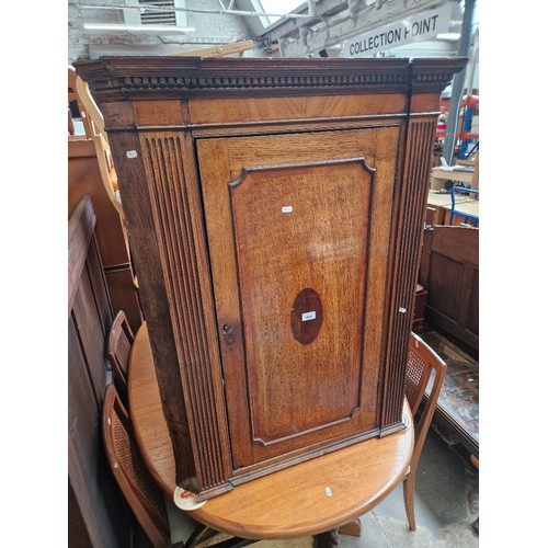 1065 - A Georgian oak corner cabinet