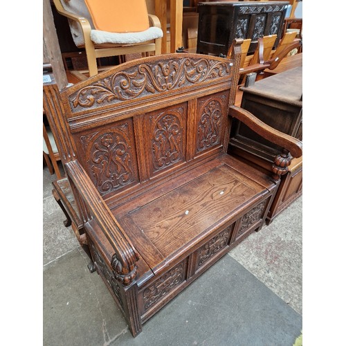 1082 - An early 20th century carved oak monks bench