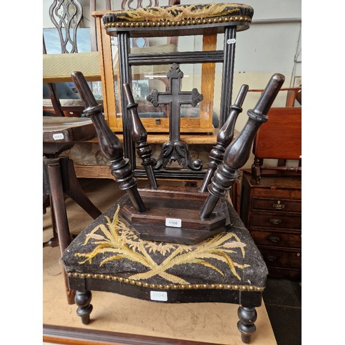 1106 - An ebonised Prie Dieu chair together with a carved ebonised table.