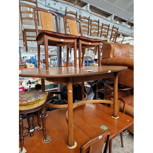 1123 - An Ercol Golden Dawn elm 'Saville' extending dining table and six chairs.