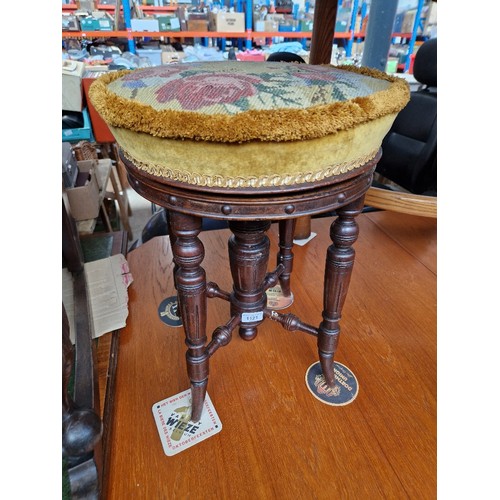 1121 - A late Victorian mahogany adjustable piano stool