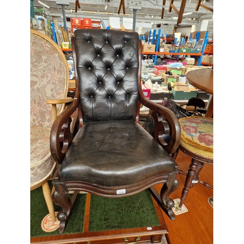 1118 - A 19th century mahogany and black leather rocking chair