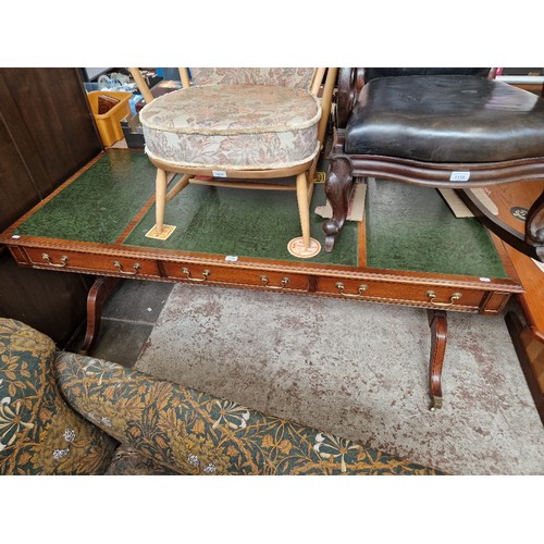 1119 - A mahogany and green leather partner's desk