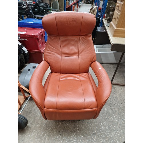 1134 - A leather recliner swivel armchair.