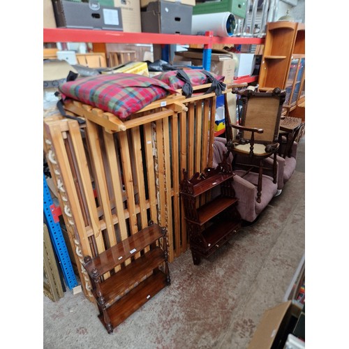 1095 - Various items of furniture to include a pine famed futon, 2 mahogany shelving units, a pair of swive... 