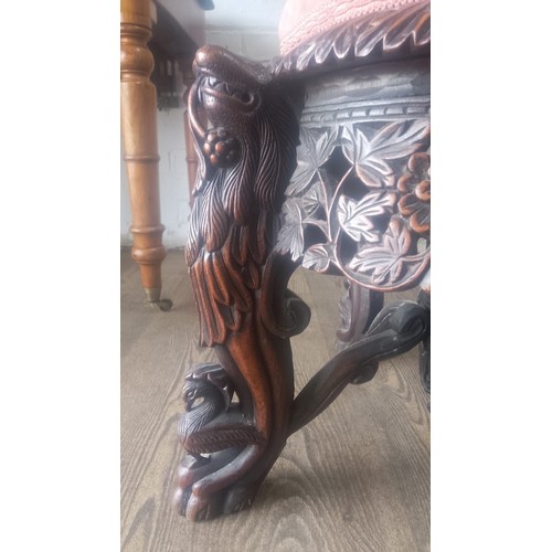 961 - A 19th century Anglo Indian carved rosewood chair, the legs modelled as stylised lions, the back car... 