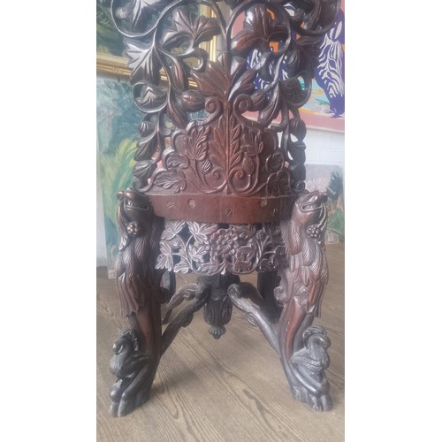 961 - A 19th century Anglo Indian carved rosewood chair, the legs modelled as stylised lions, the back car... 